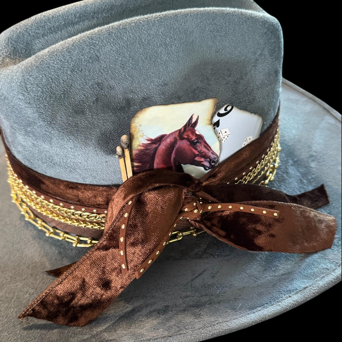 Blue cowboy hat by Sunkissed by Chrissy with 18k gold jewels, western rodeo style, perfect for country concerts and cowgirl outfits.