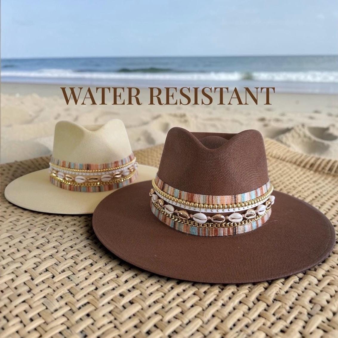 Women’s wide brim waterproof boater hat by Sunkissed by Chrissy with gold embellishments, straw panama style, perfect for beach and resort wear.