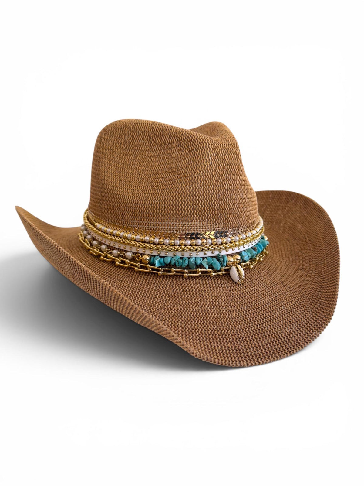 Woman wearing a turquoise cowboy hat at a beach vacation, showcasing boho summer festival resort style accessory.