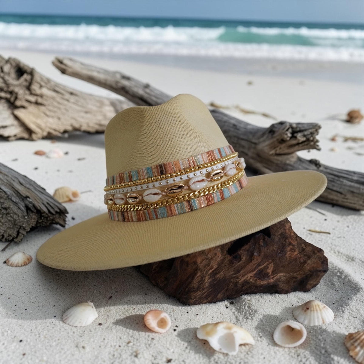 Women’s waterproof wide brim boater hat by Sunkissed by Chrissy, featuring luxury straw design, shell band, and gold embellishments.
