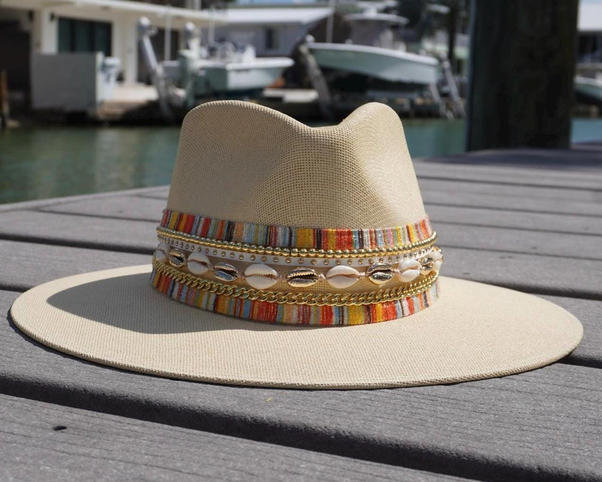 Women's wide brim boater hat by Sunkissed by Chrissy with gold embellishments, straw Panama style, perfect for beach and resort wear.