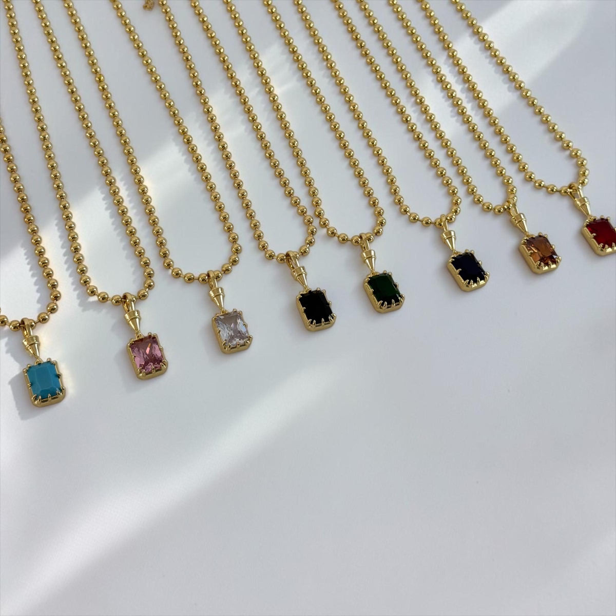 Gold gemstone pendant necklace featuring a solitaire birthstone, elegant and minimalist jewelry by Sunkissed by Chrissy.