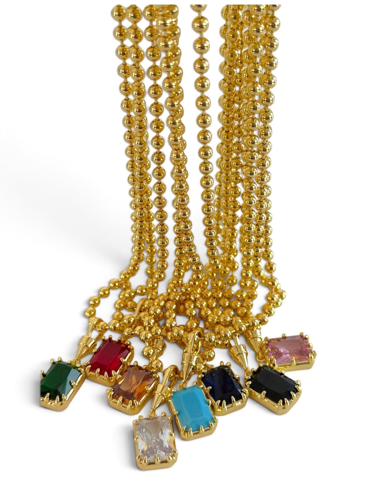 Gold gemstone necklace with a solitaire pendant featuring a birthstone, elegant jewelry for weddings, layering, or everyday wear.