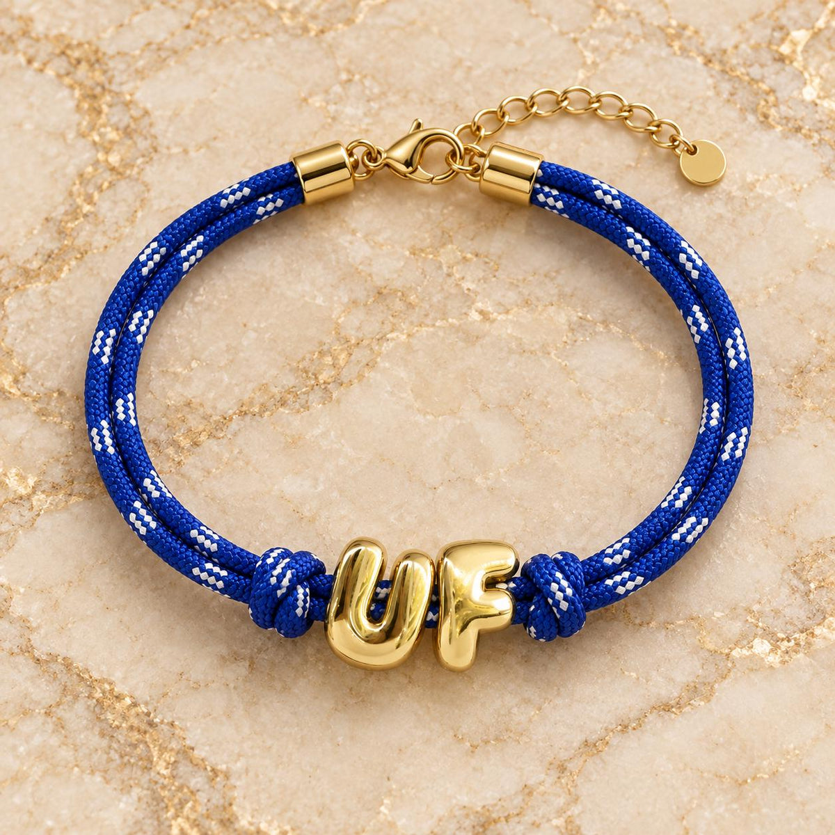 Personalized Sunkissed by Chrissy paracord bracelet with gold initials, adjustable Gameday wristband in Europe style, shown on a wrist.
