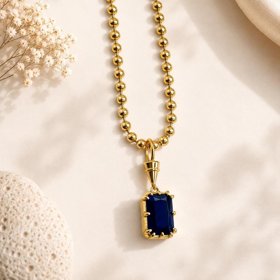 Gold gemstone pendant necklace by Sunkissed by Chrissy featuring a solitaire birthstone, elegant dainty jewelry for everyday wear.
