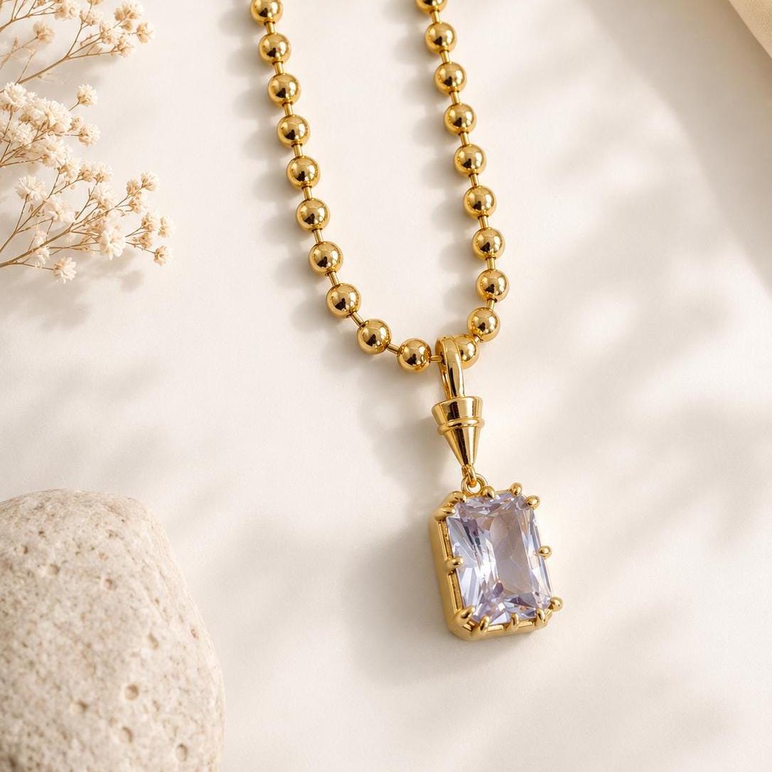 Gold gemstone pendant necklace by Sunkissed by Chrissy featuring a solitaire birthstone charm for elegant, minimalist jewelry.