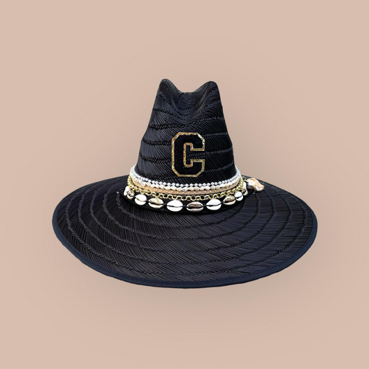 Black straw sun hat by Sunkissed by Chrissy, featuring wide brim and lifeguard style, perfect for beach and summer vacations.
