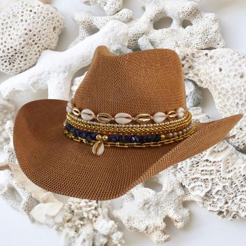 Jeweled cowboy beach hat by Sunkissed by Chrissy with straw design, decorative shells, perfect for summer coastal and tropical vacations.