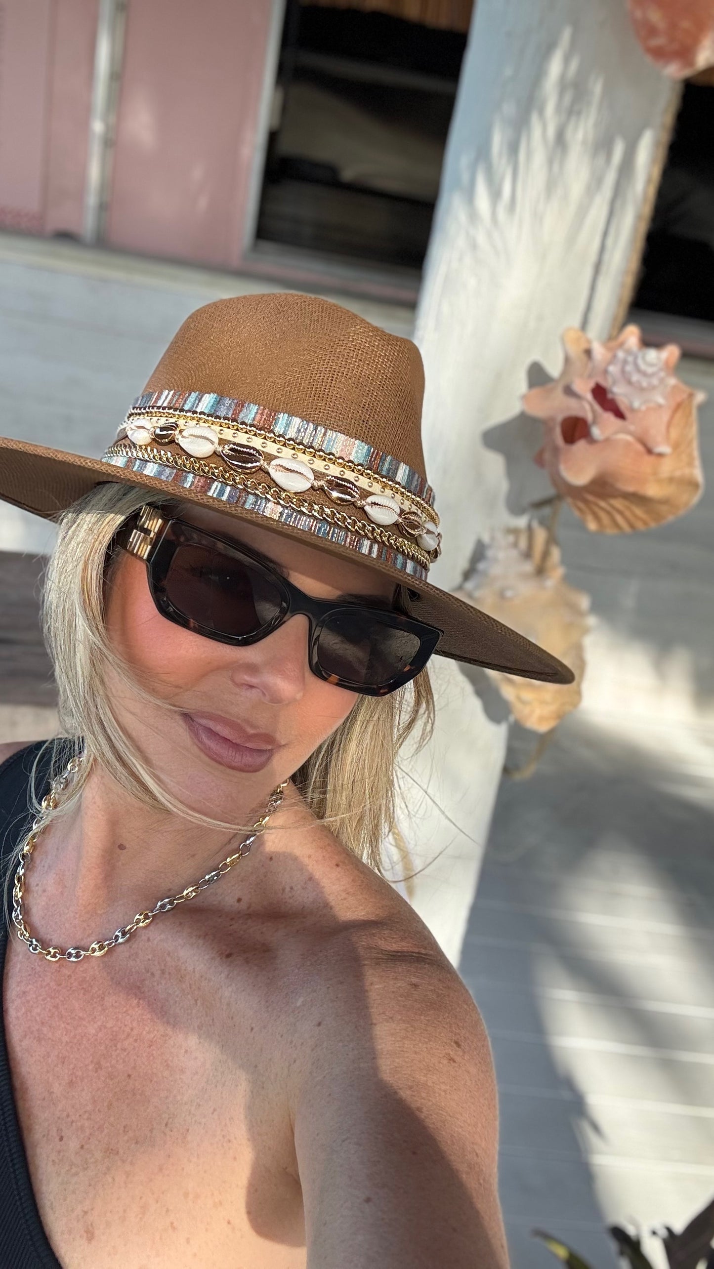 Water-resistant beach hat by Sunkissed by Chrissy with shell accents, coastal jute material, and a classic Panama boater style for women.