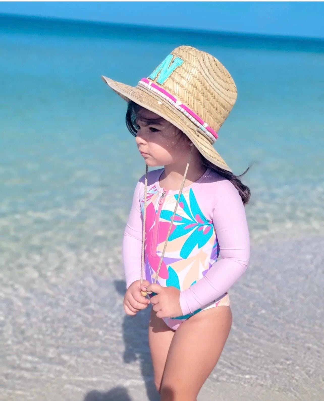Personalized Sunkissed by Chrissy kids straw sun hat with initial chenille letter, perfect for toddlers at the beach or as a birthday gift.