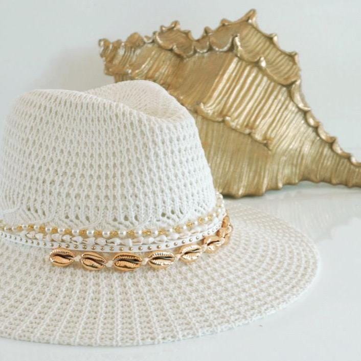 Handmade beach hat by Sunkissed by Chrissy featuring cowrie shells and pearls, perfect for summer pool days and beach vacations.