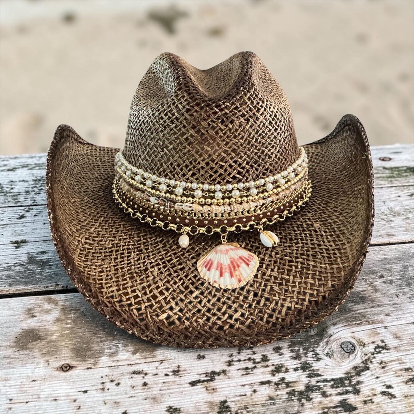Brown straw cowboy hat with beaded coastal seashell charm, perfect for summer festivals and beach resort vacations.