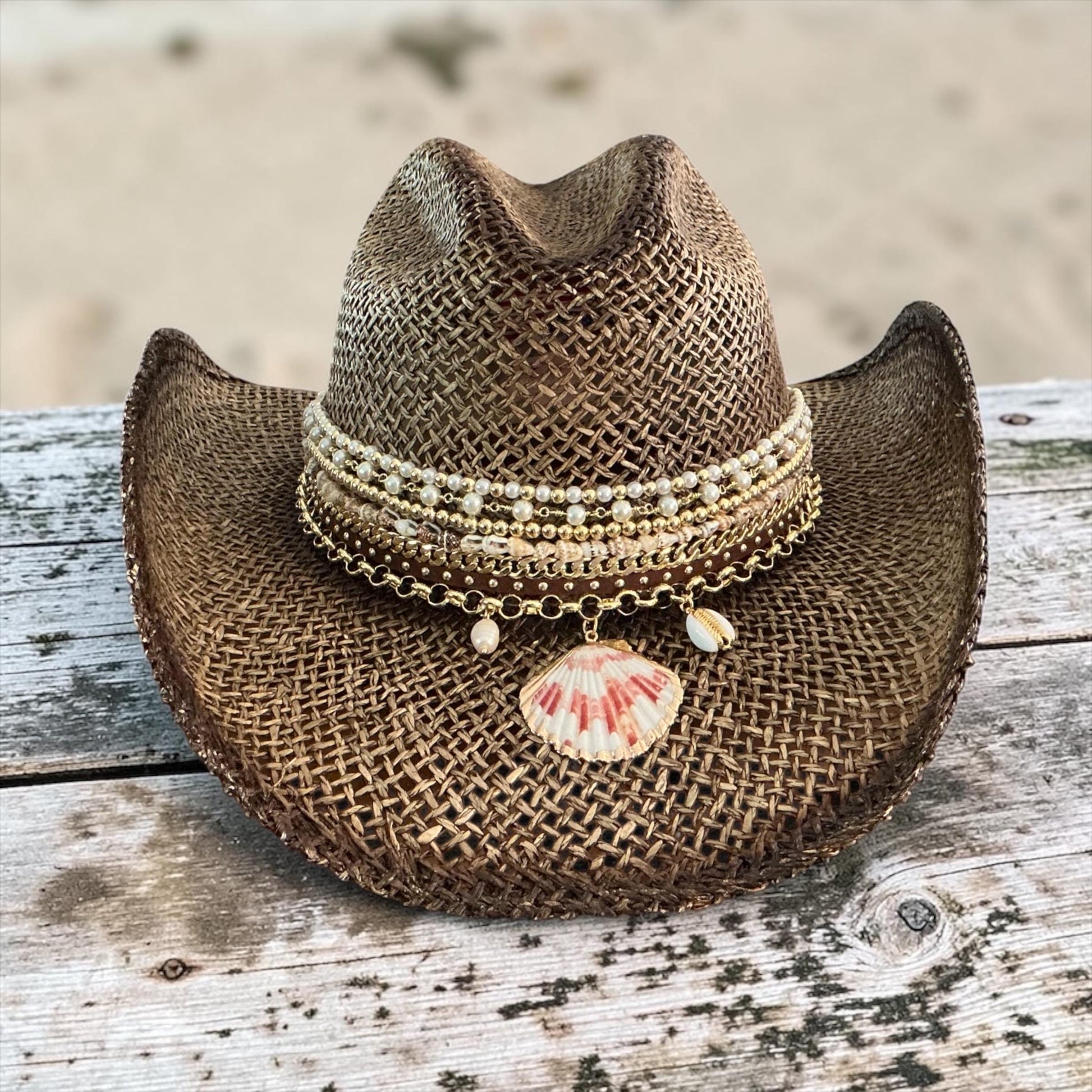 Brown straw cowboy hat with beaded coastal seashell charm, perfect for summer festivals and beach resort vacations.