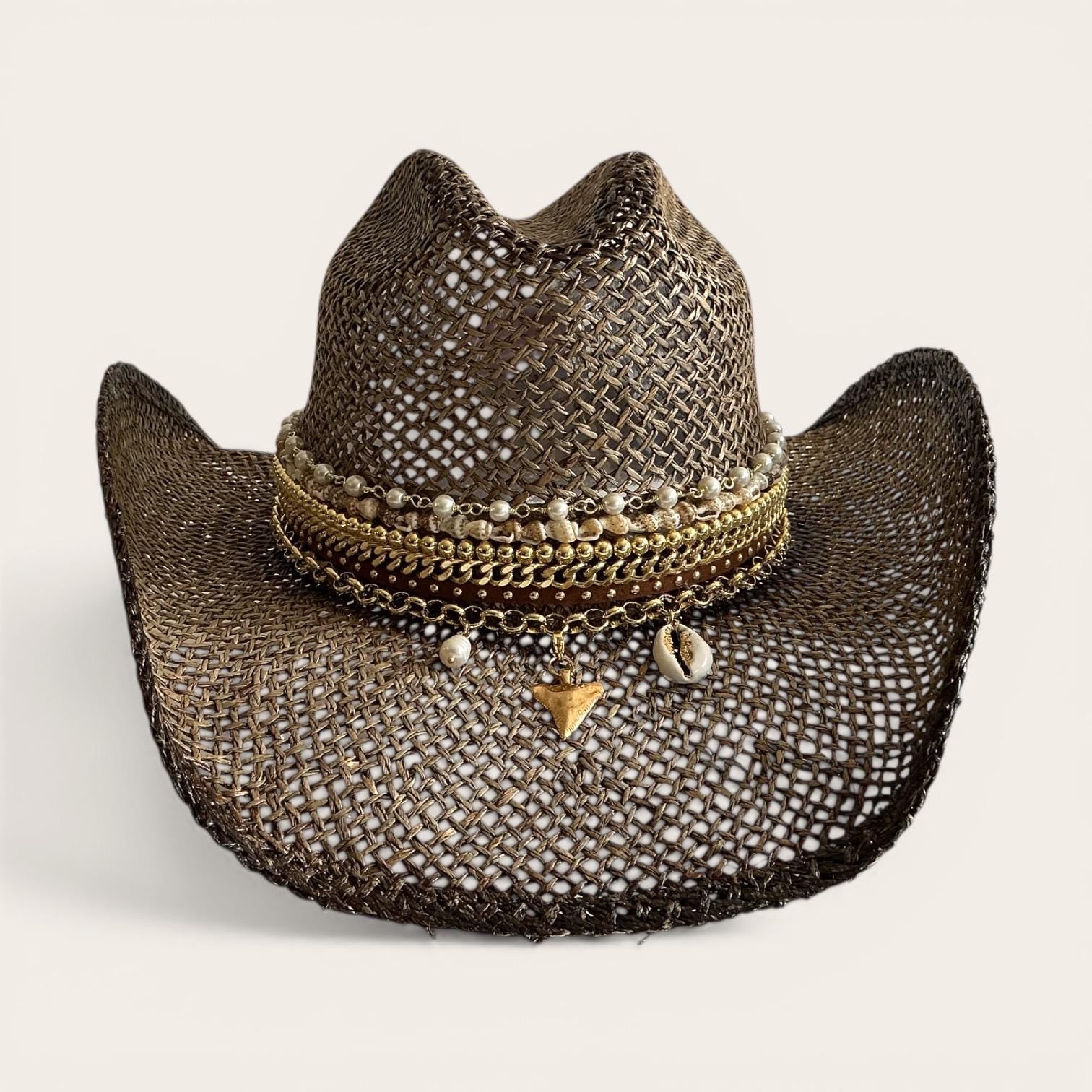 Brown straw cowboy hat by Sunkissed by Chrissy with beaded seashell charm, perfect for summer festivals and beach vacations.