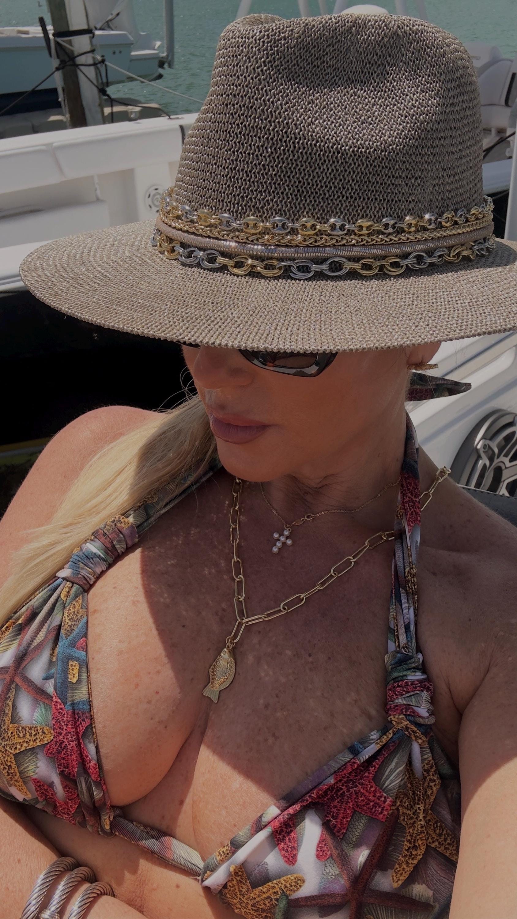 Mixed metal chain wide brim sun hat for women, luxury Panama style with neutral tones, perfect for beach and resort vacation wear.