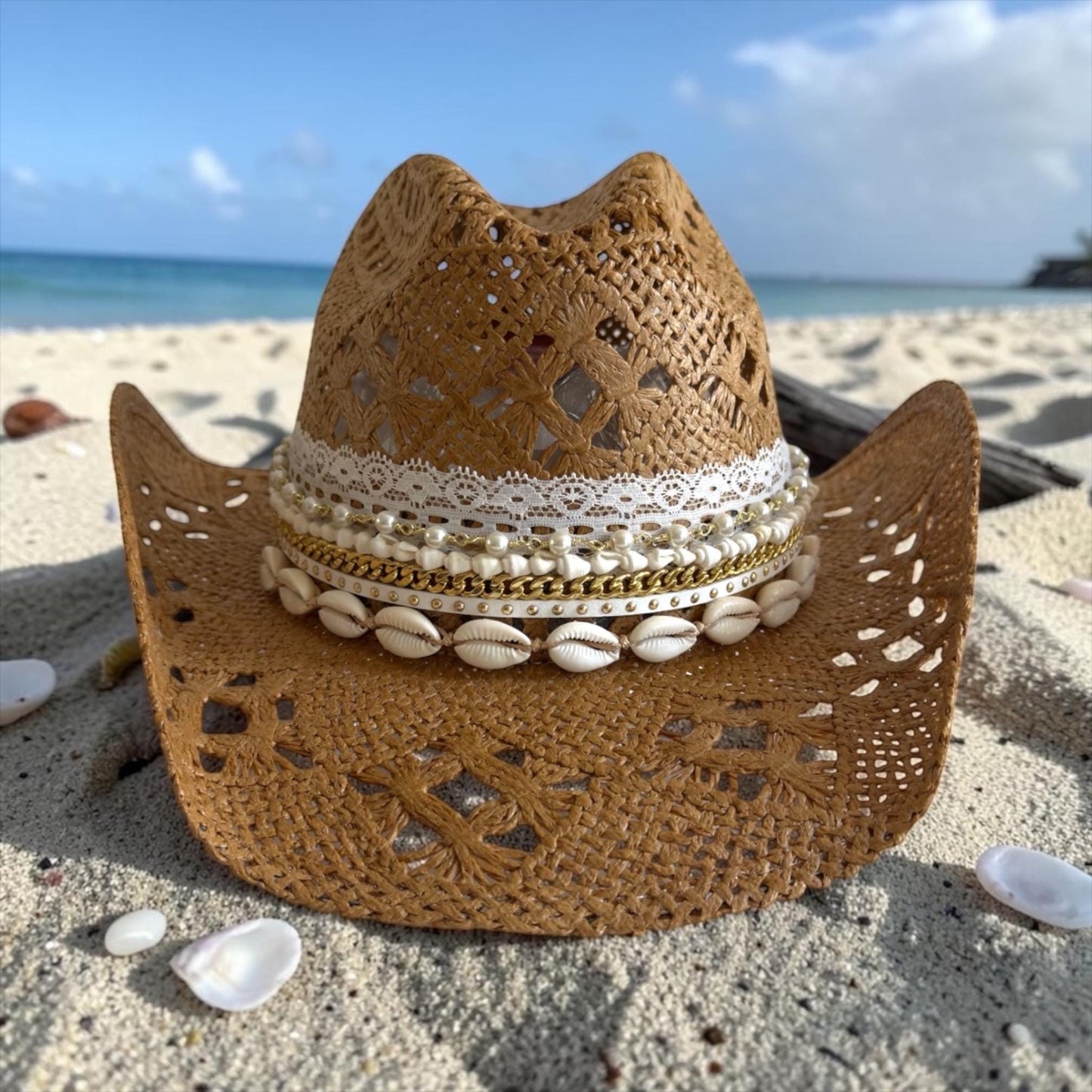 Luxury straw cowboy hat for women with shell trim, wide brim, boho style, perfect for beach, resort, or summer vacation.