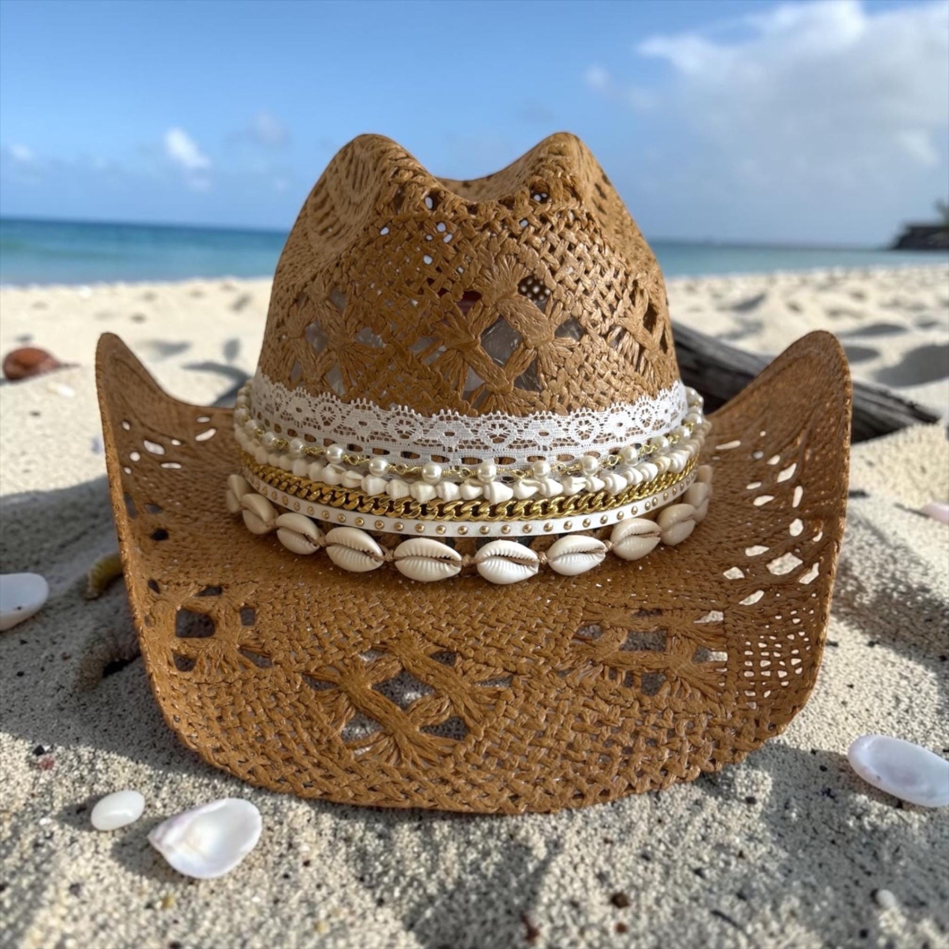 Luxury straw cowboy hat for women with shell trim, wide brim, boho style, perfect for beach, resort, or summer vacation.