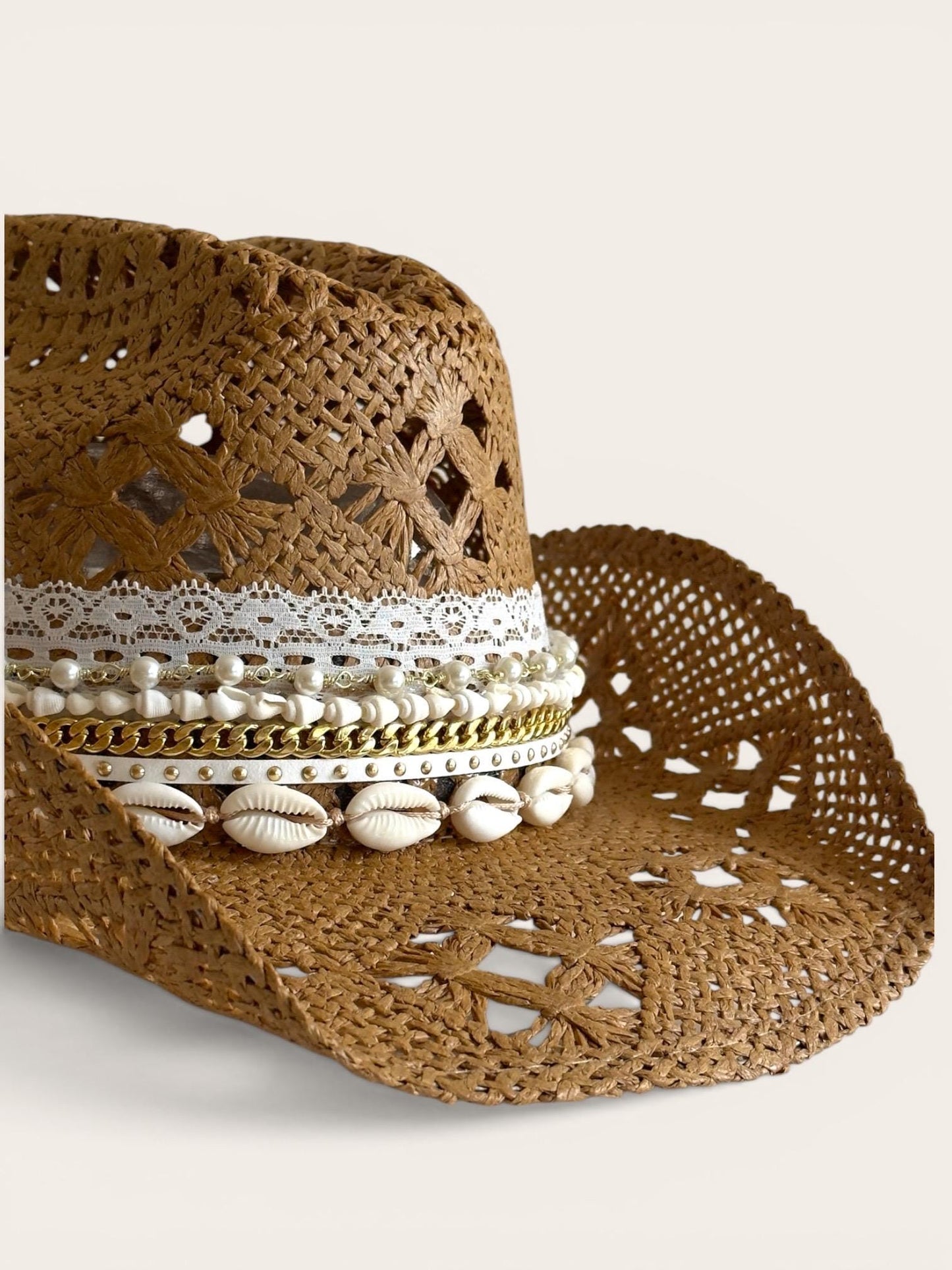Luxury straw cowboy hat for women with shell trim, wide brim, coastal boho style, perfect for beach and summer resort vacations.