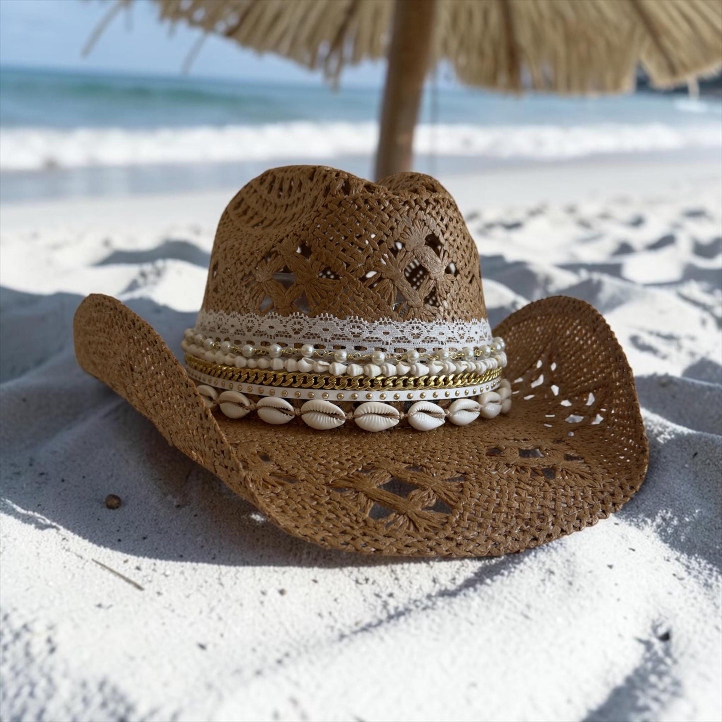 Luxury straw cowboy hat for women with wide brim, shell trim, beach style, boho design, ideal for summer resort and vacation wear.