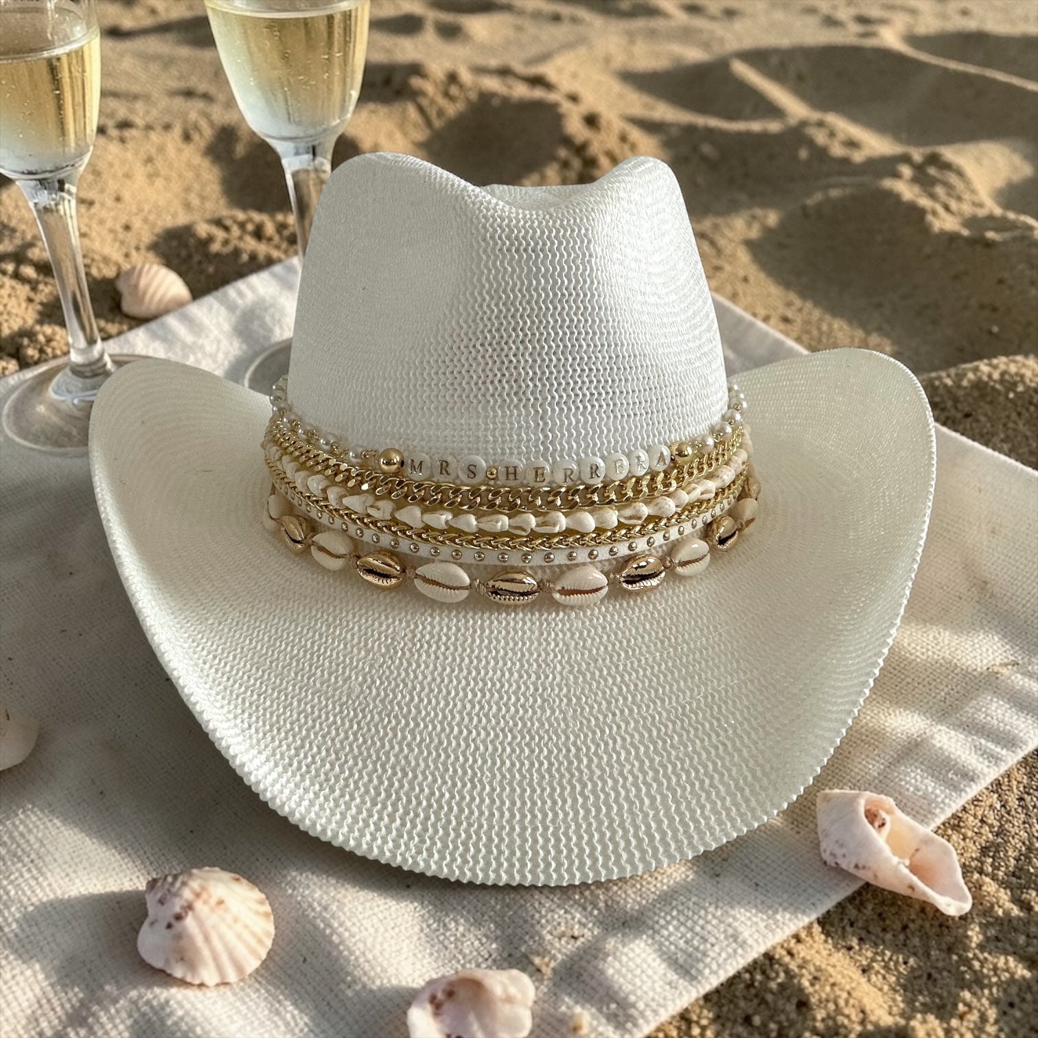 White Coastal cowgirl custom jeweled hat by Sunkissed by Chrissy, perfect for beach, resort, or bachelorette vacation wear.