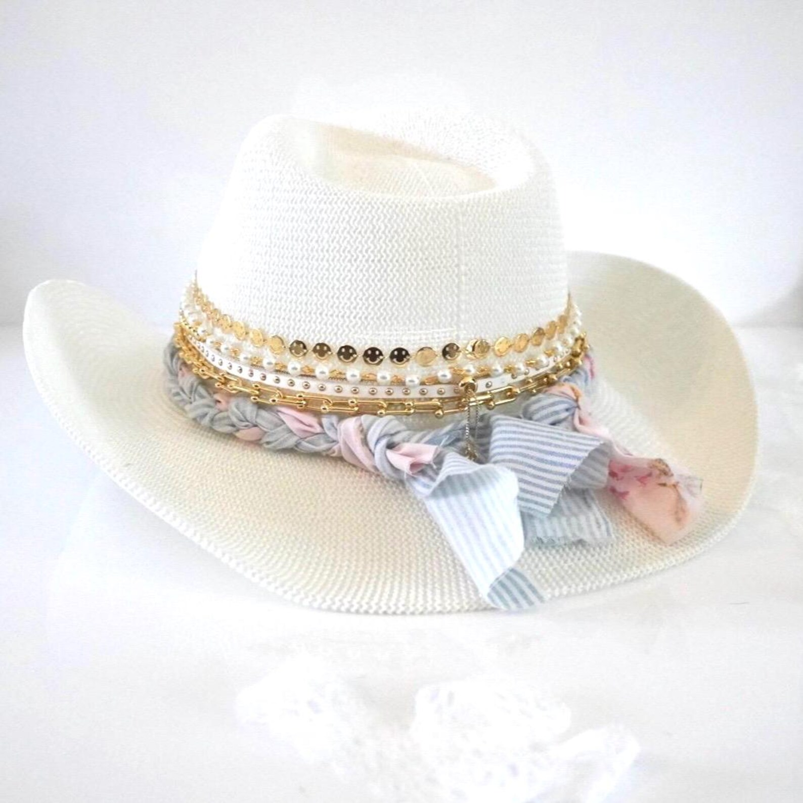 White cowboy hat by Sunkissed by Chrissy featuring a jeweled coquette bow, embellished details, perfect for shabby chic resort wear.