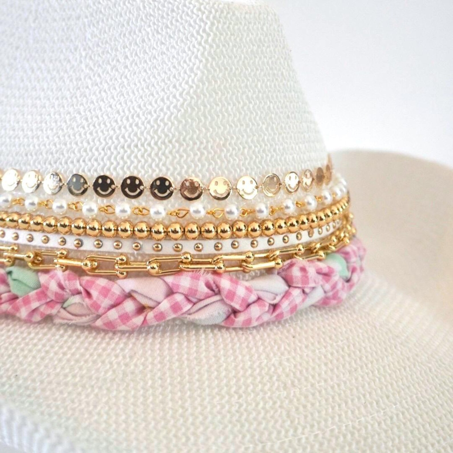 White cowboy hat by Sunkissed by Chrissy with jeweled bow embellishment, perfect for vacation or resort wear.