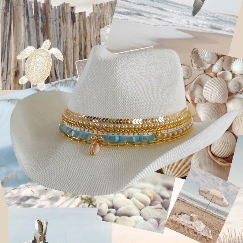 Luxury white cowgirl beach hat with shells, gold jewelry accents, handmade straw design, perfect for summer resortwear and coastal style.