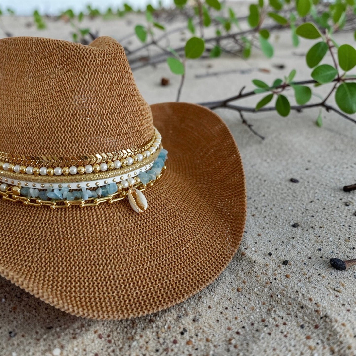 Luxury white straw cowgirl beach hat with shells and gold jewelry accents, perfect for summer resortwear and boho coastal style.